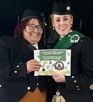 Two women in black and green attire holding a green sign

AI-generated content may be incorrect.