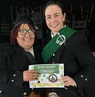 Two women in black suits holding a green sign

AI-generated content may be incorrect.