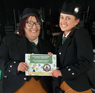 Two women in matching outfits holding a sign

AI-generated content may be incorrect.